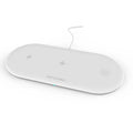 White three-in-one wireless charging station for Apple iPhone, iWatch, and earbuds on a desk.