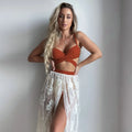 Women's creamy white backless push-up bikini three-piece set with a skirt on a neutral background.