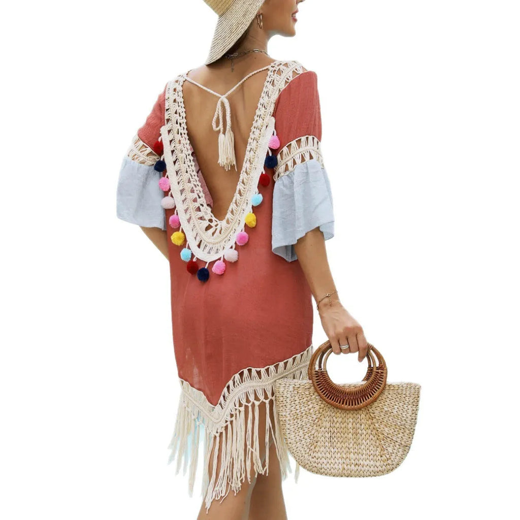 Orange beach overskirt with hand crochet floral pattern and bamboo cotton tassel detailing on mannequin