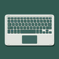Pink mute wireless Bluetooth mouse and matching touch keyboard on a desk