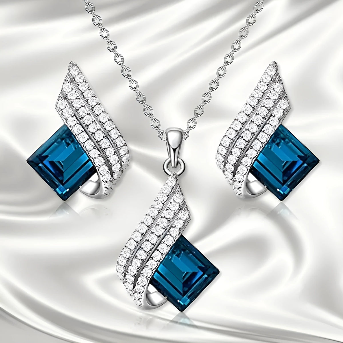 Women's jewellery set showing necklace with cross chain and matching earrings with glass elements