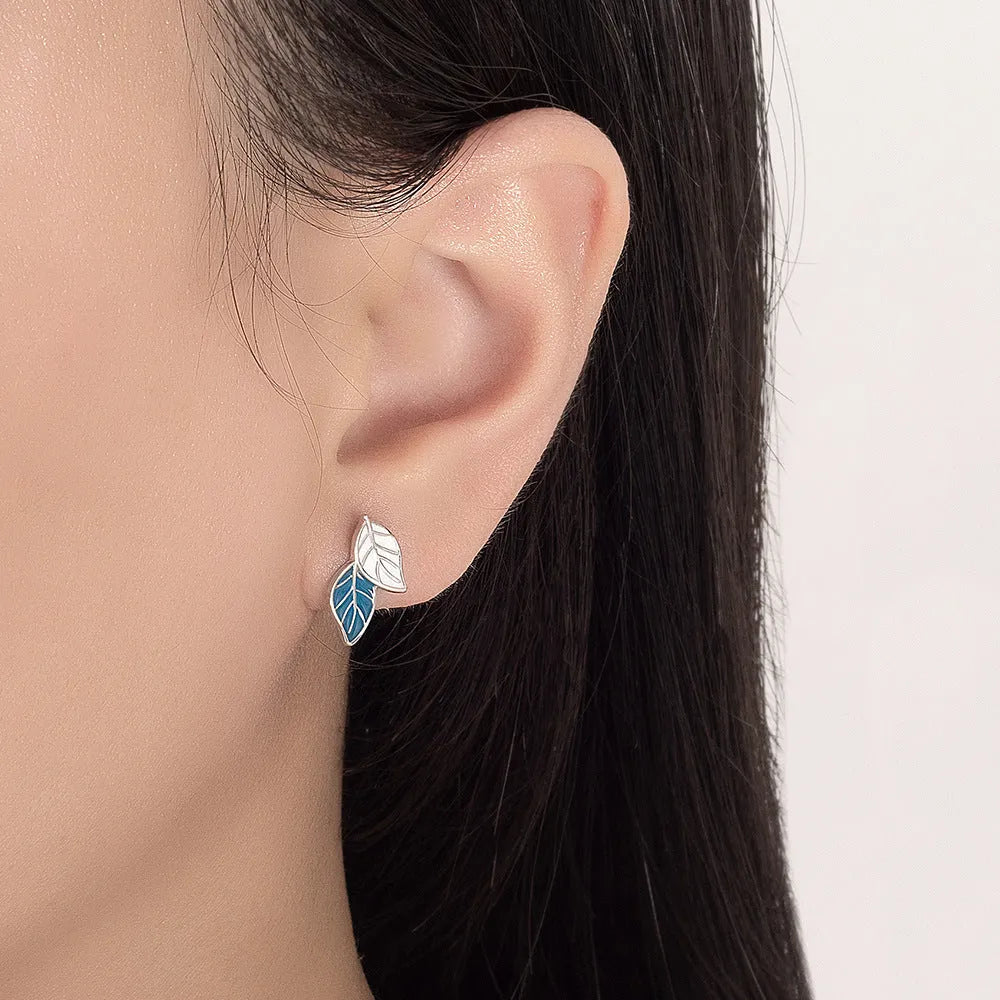 Copper leaf-shaped stud earrings with white gold colour plating and post fastening
