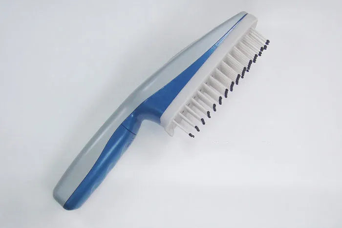 A white pet comb with a removable brush head and a handle housing negative ion and active oxygen technology.