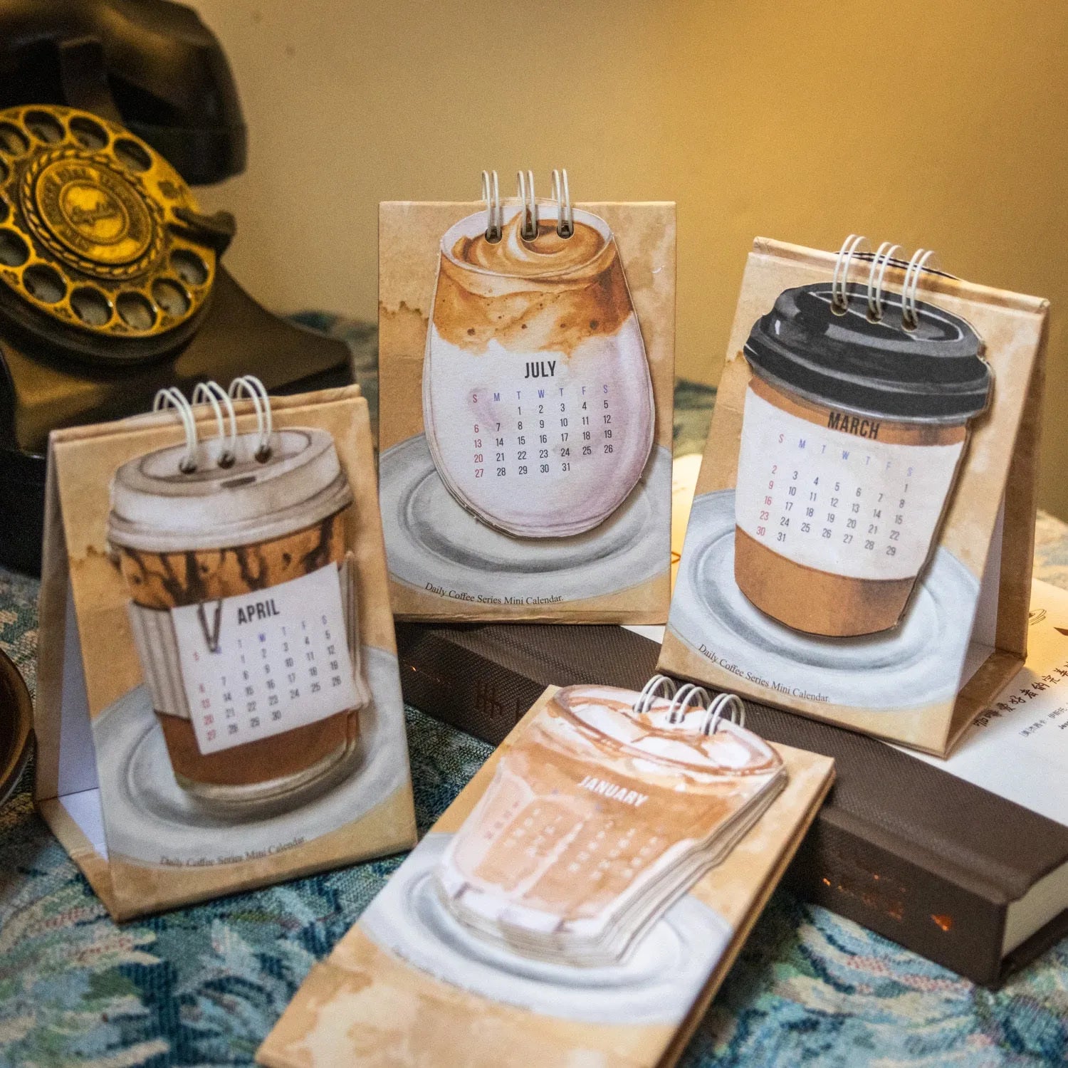 Mini 2025 desk calendar set showing four different themed designs including coffee and motivational messages.