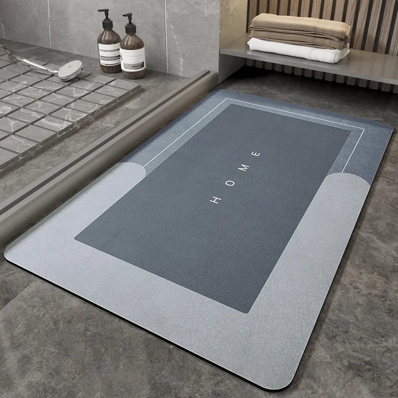 Blue oval blended bathroom floor mat on tiled floor next to a bath.