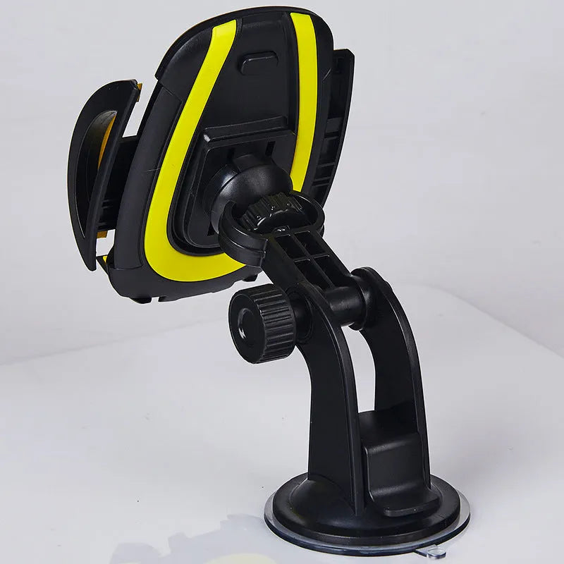 Red U-shaped car phone holder with suction cup base and adjustable clamp arms on a vehicle dashboard
