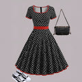 Women's square collar short sleeve dress with polka dot print, front zipper, and pleated mid-length skirt.