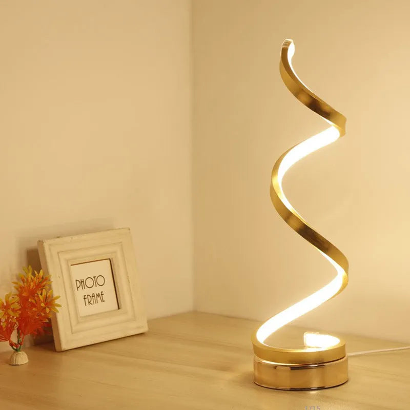 Black minimalist LED bedside table lamp with aluminium shade and metal base on wooden table