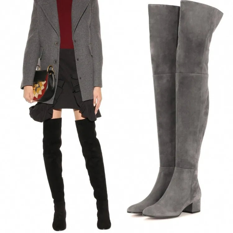 Grey women's suede over-the-knee flat boots with a pointed toe and low thick heel.