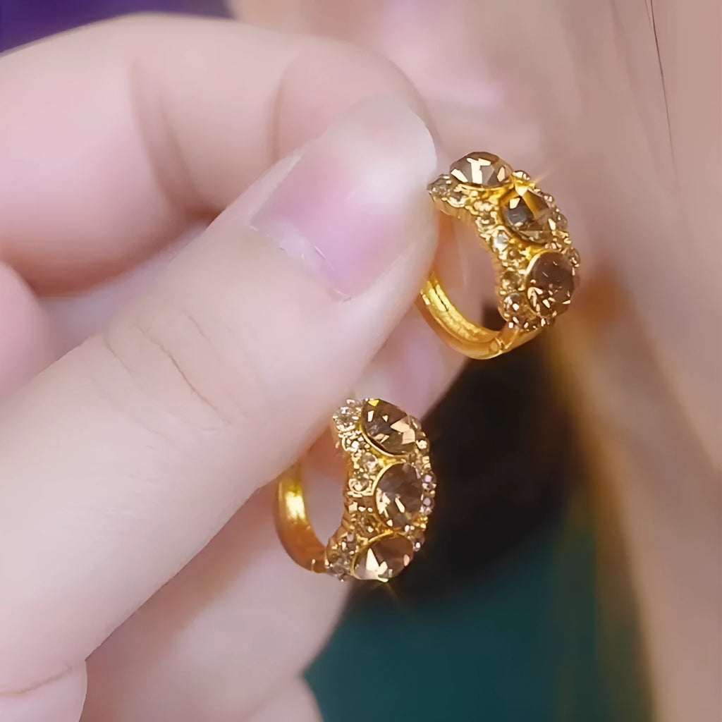 Gold metal hoop earrings with diamond surface treatment and brown zircon stones