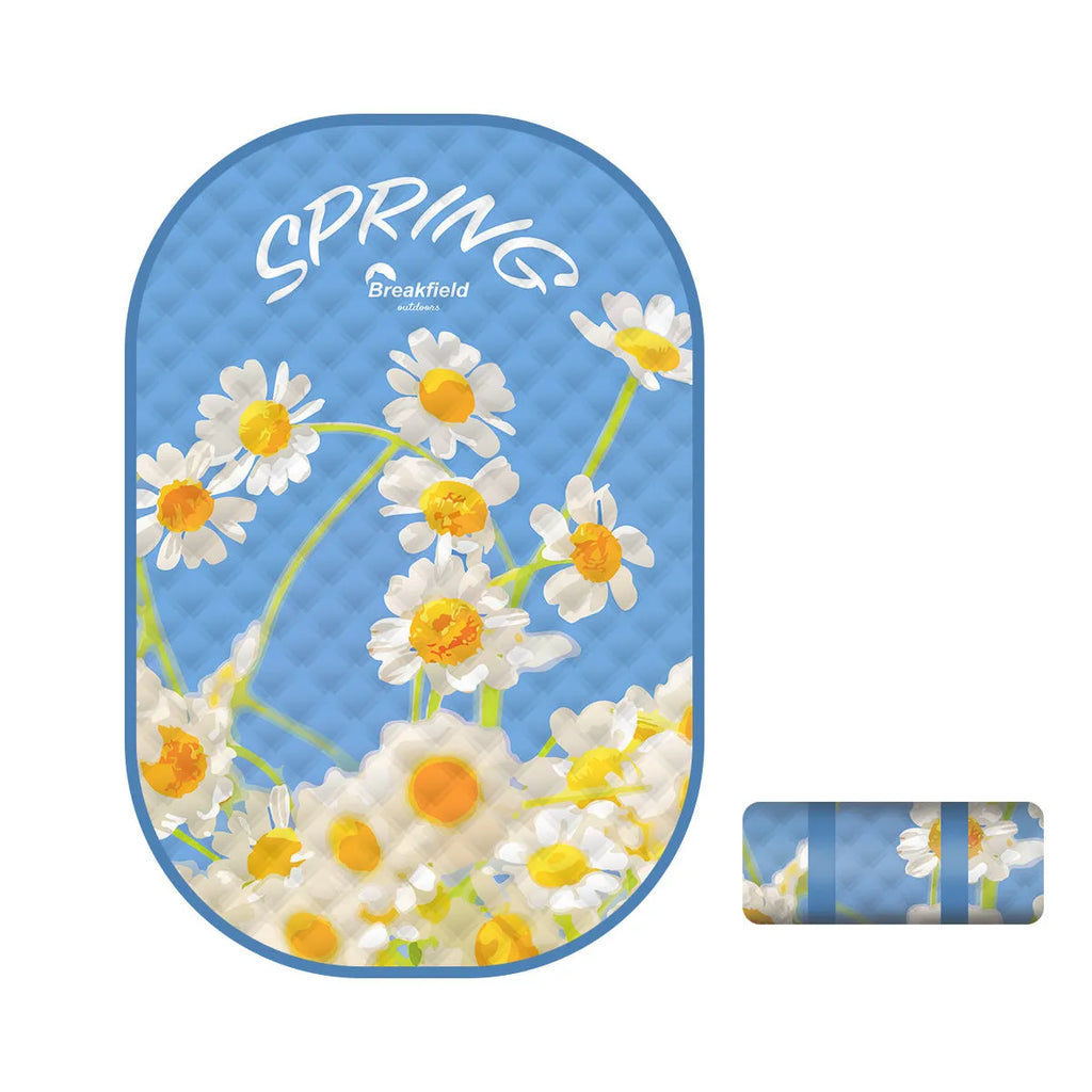 Waterproof thickened picnic mat in a seasonal colour, laid out flat on grass.