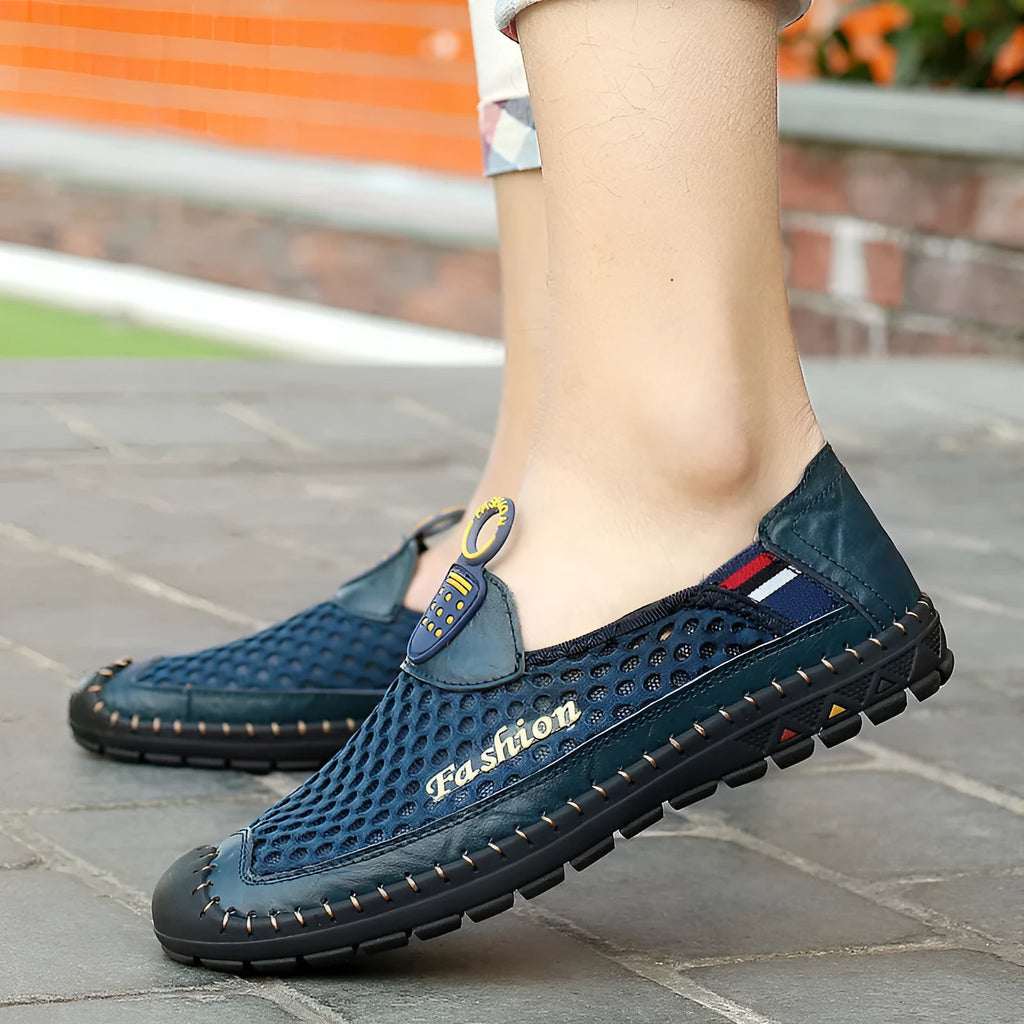 Men's brown casual shoes with mesh fabric upper and rubber sole, showing round toe and shallow-cut design.
