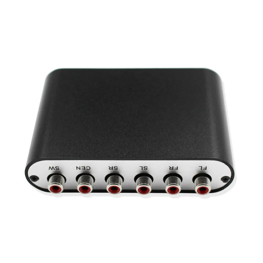 Black DTS Dolby AC-3 audio decoder unit with optical and coaxial inputs on a desk.