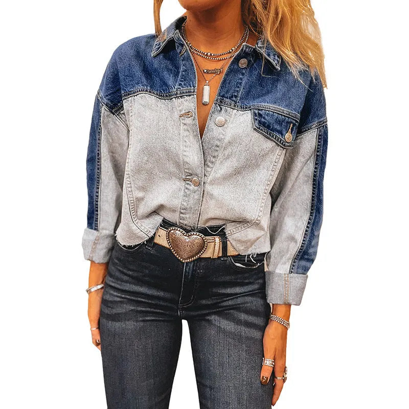 Women's loose blue denim coat with a row of silver buckle closures down the front.