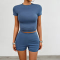 Women's solid colour slim fit sports suit 2-piece set with viscose t-shirt and elastic shorts.