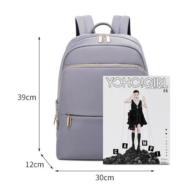 Women's large capacity oxford cloth backpack in black, showing front compartments and shoulder straps.