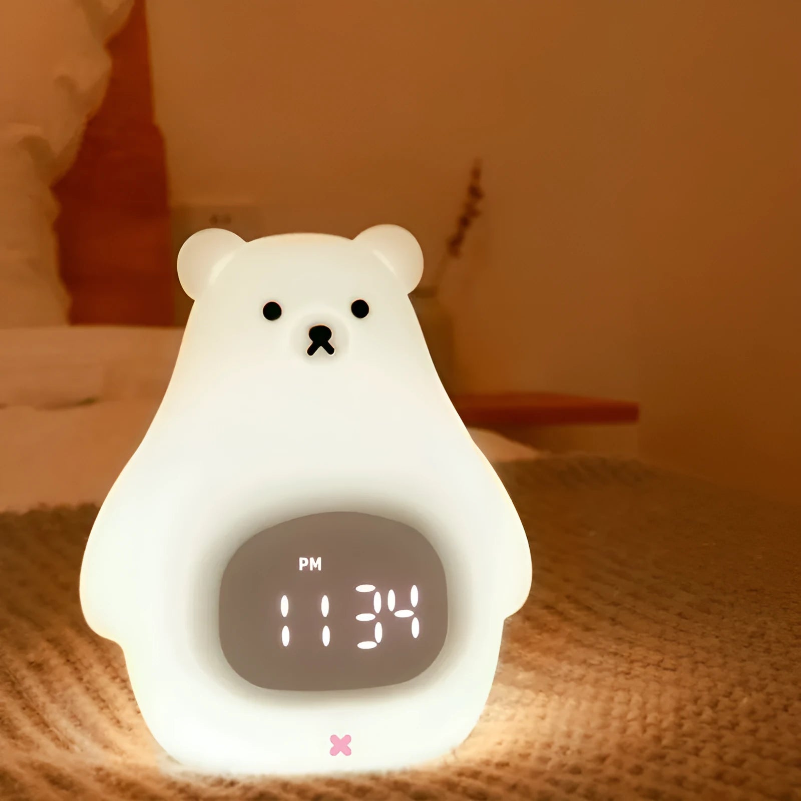 A white silicone night light shaped like a bear with a sleep timer and remote control.