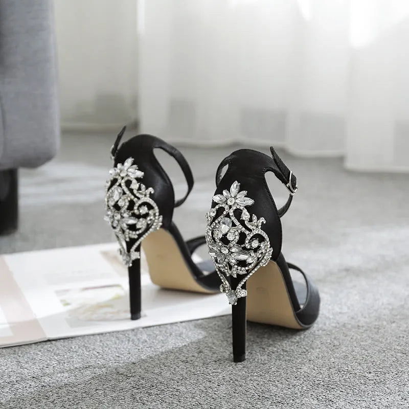 Black suede women's high heel shoes with rhinestone detail and a fishmouth open toe.