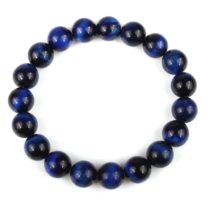 Finished round tiger eye crystal bracelet in multiple colour options on a wrist.