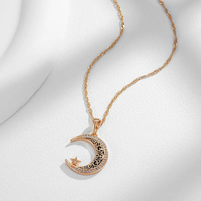 Rose gold star and moon zircon pendant necklace with enamel detail on a water wave chain.