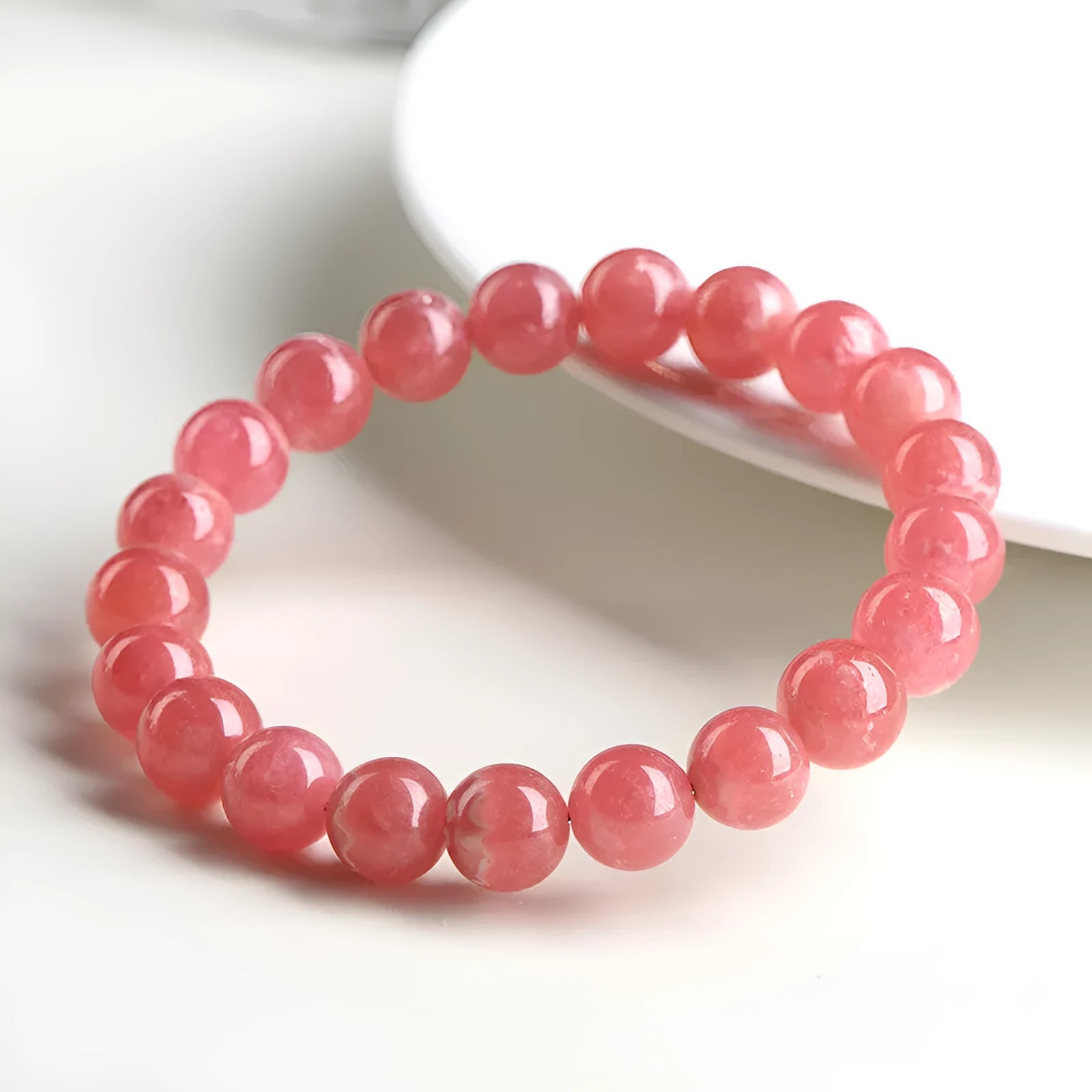 Women's red rhodochrosite crystal bracelet with geometric beads and longevity lock clasp