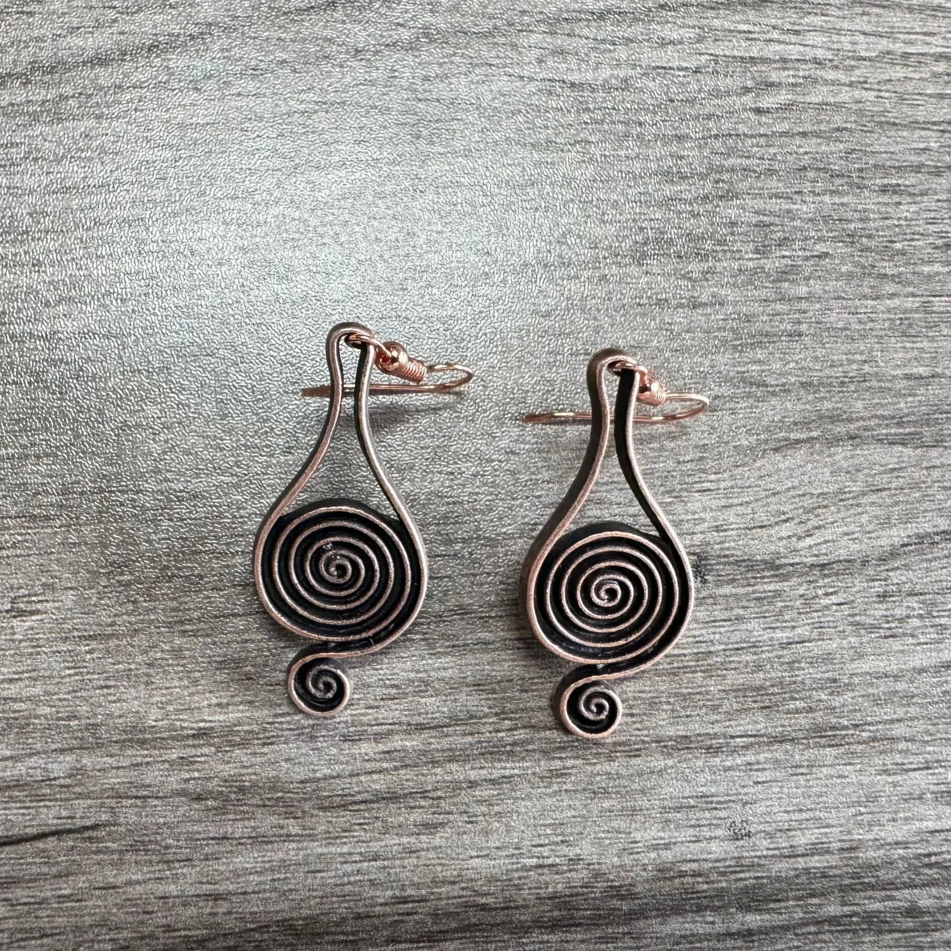 Bronze spiral psychedelic drop earrings with geometric shape and alloy construction