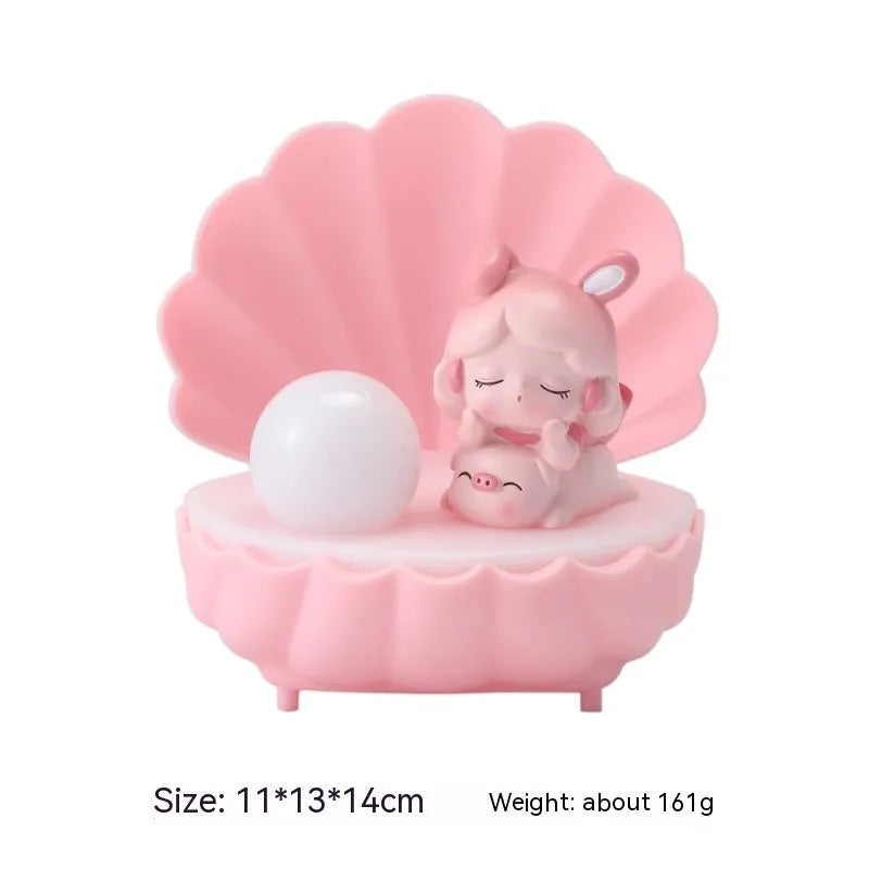 Resin cartoon small night lamp with pink pig girl design on a table