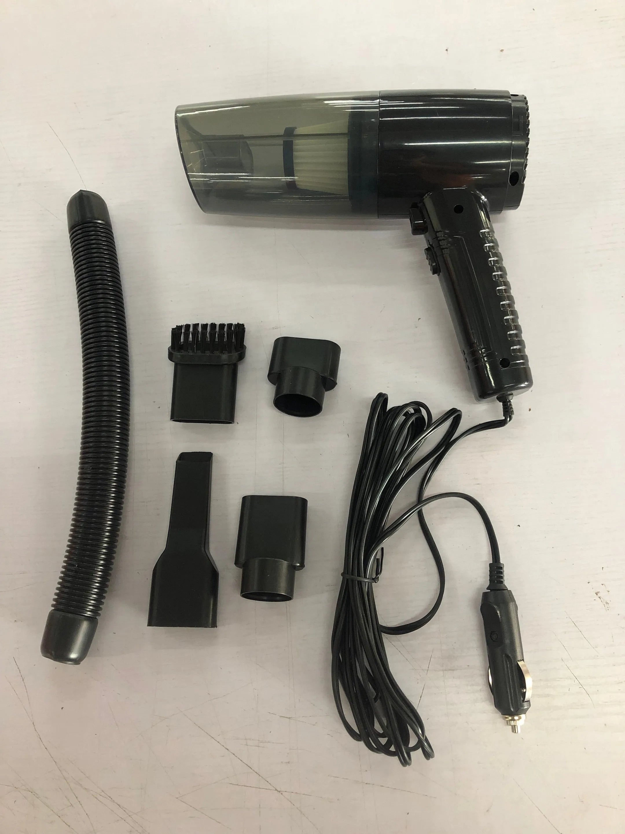 Starry Sky Black and Pearl White car vacuum cleaner with motor and five suction head accessories.