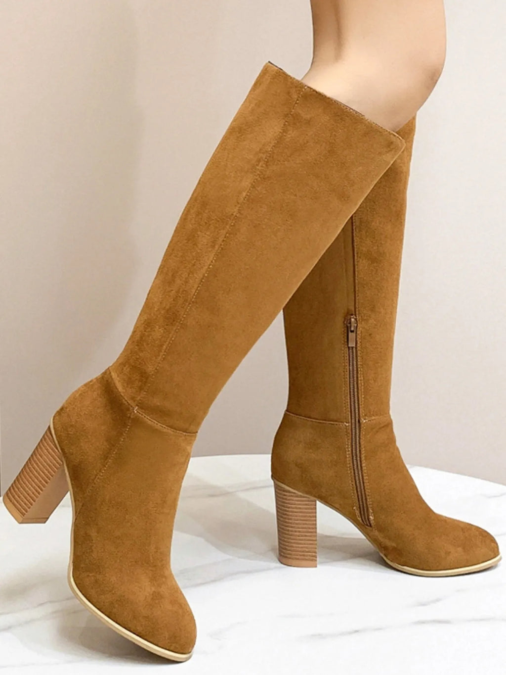 Women's black square toe high heel fashion boot made of artificial PU material.