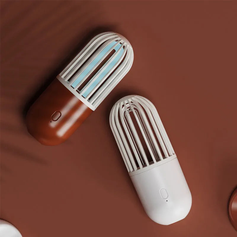 Portable capsule-shaped ultraviolet UVC disinfection lamp in black, showing compact size.