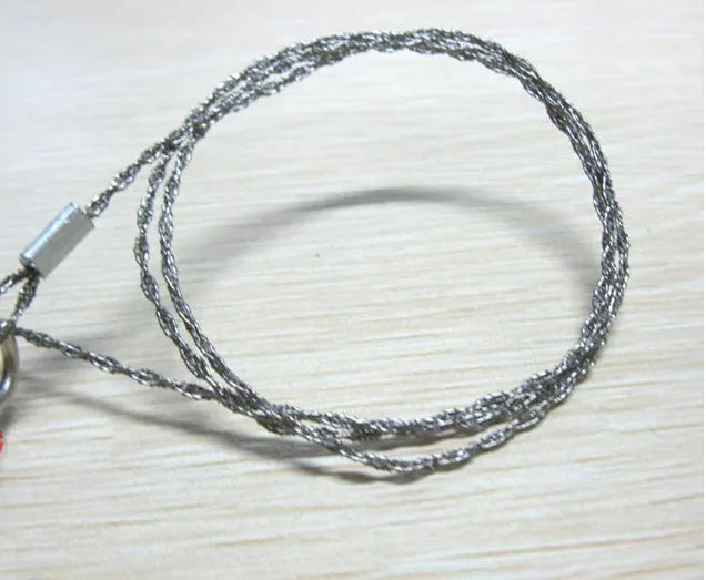Survival wire saw with stainless steel blade and thumb rings for outdoor cutting tasks