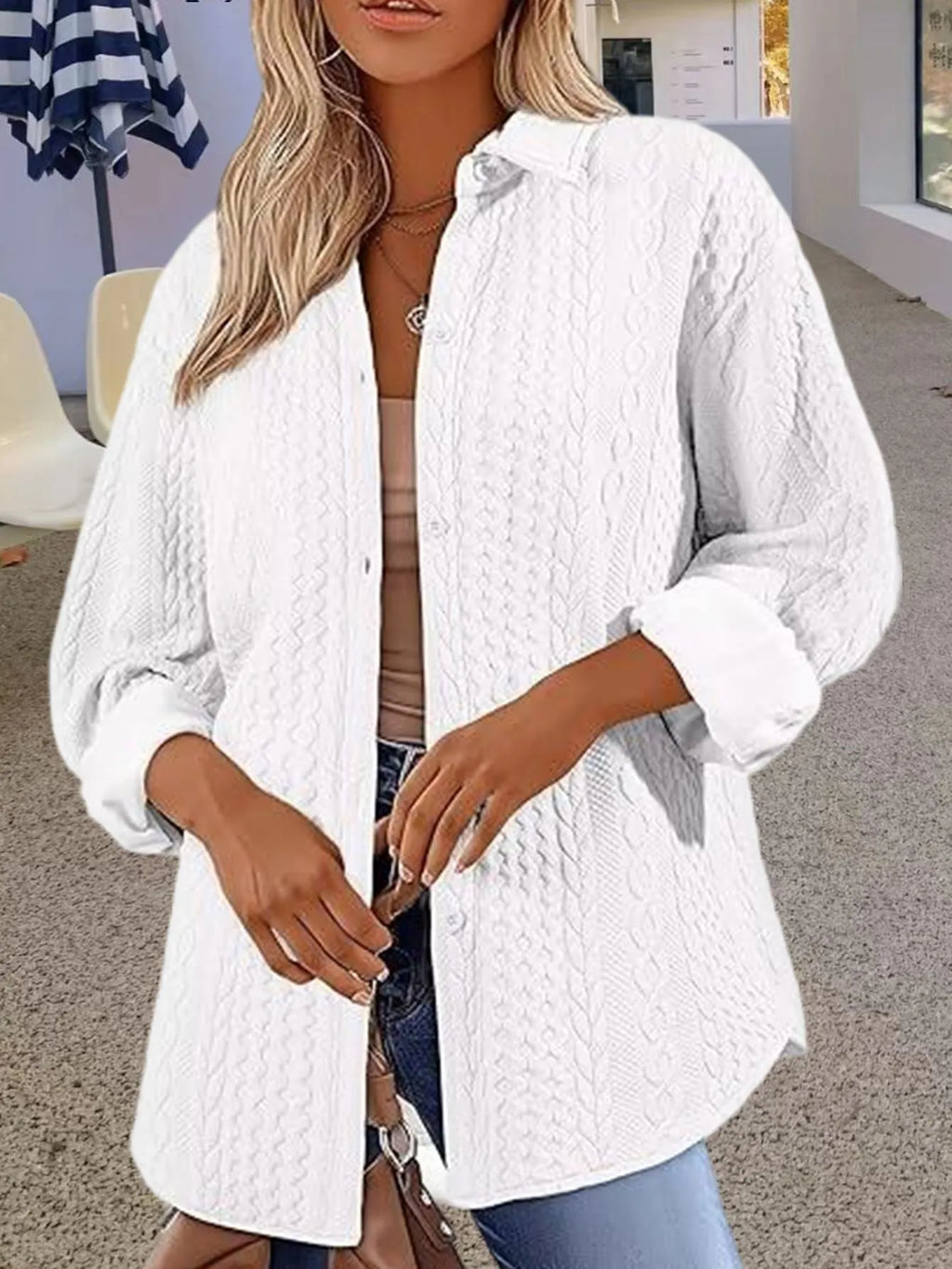 Women's solid colour long-sleeved knitted cardigan sweater on a hanger.