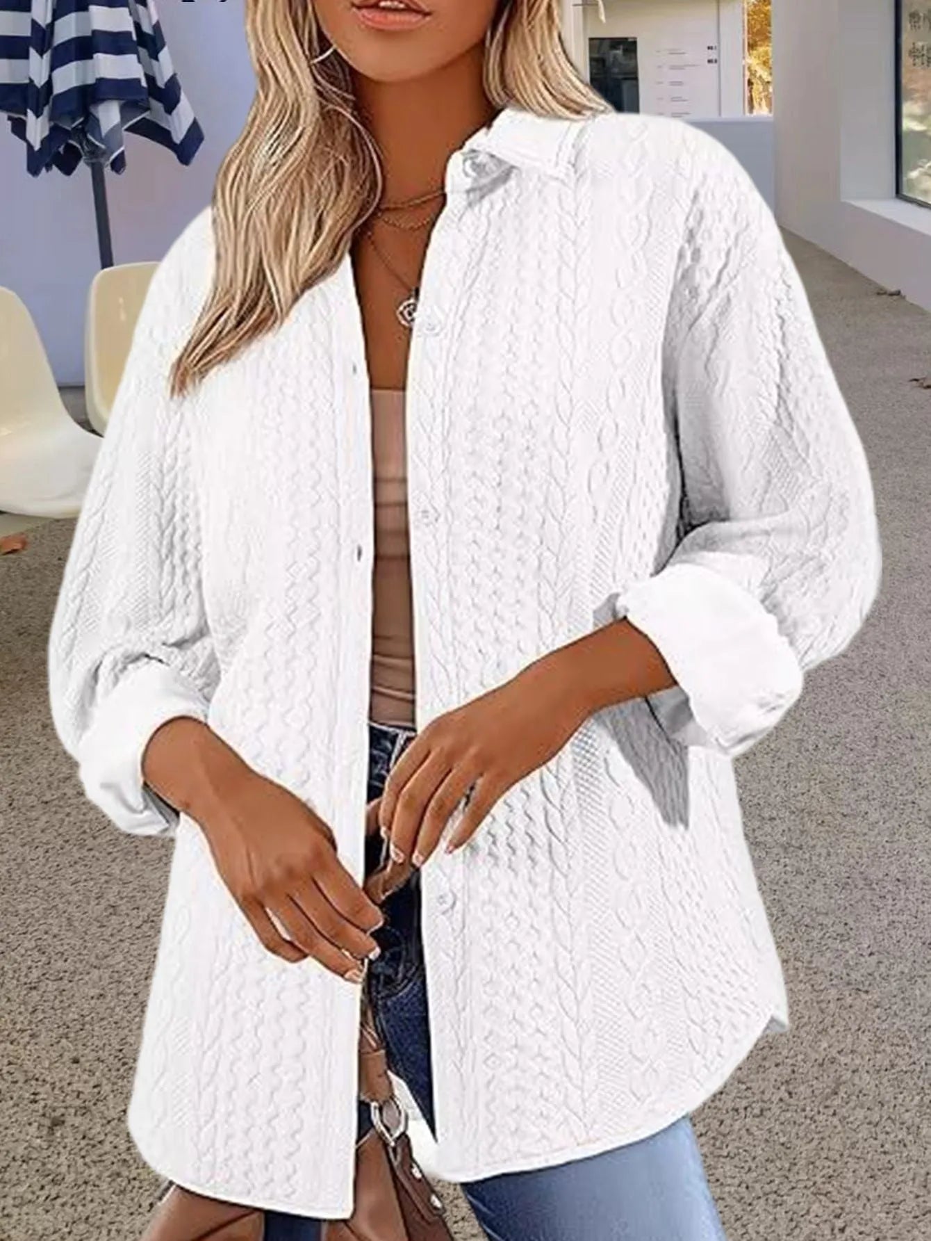 Women's solid colour long-sleeved knitted cardigan sweater on a hanger.