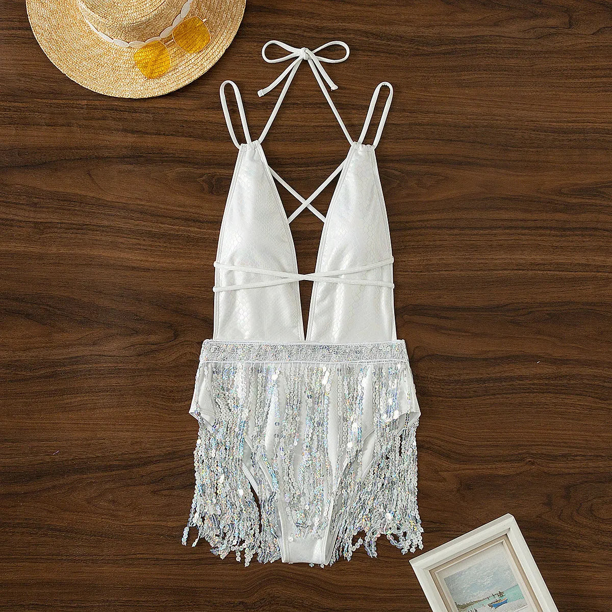 White deep V neck one-piece swimsuit with tassel detail and sleeveless design