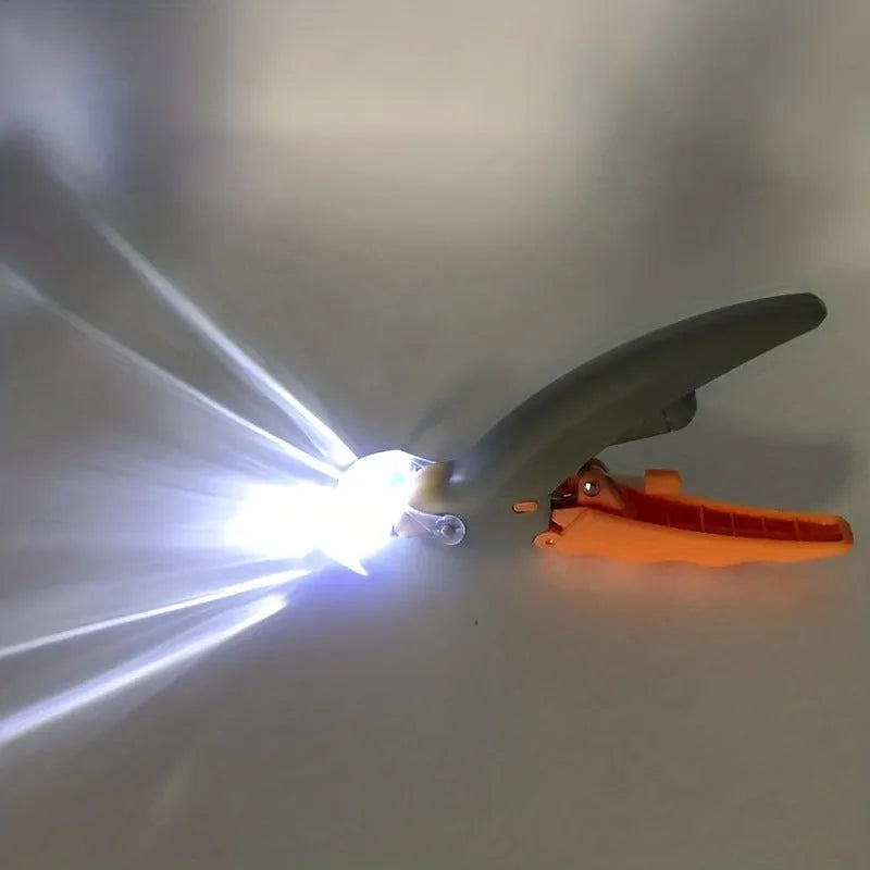 Yellow LED pet nail trimmer with magnifying glass and light on, for trimming cat and dog claws.