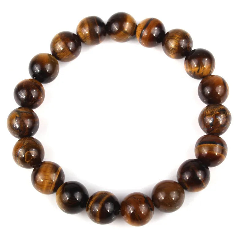 Finished round tiger eye crystal bracelet in multiple colour options on a wrist.