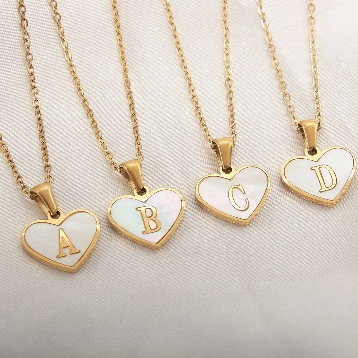 Personalised white shell heart necklace with gold chain and initial letter engraving
