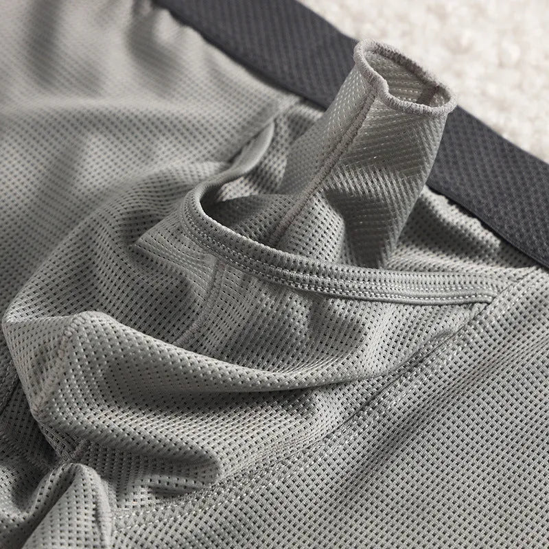 Men's solid colour ice silk boxer shorts on a white background, showing low waist design.