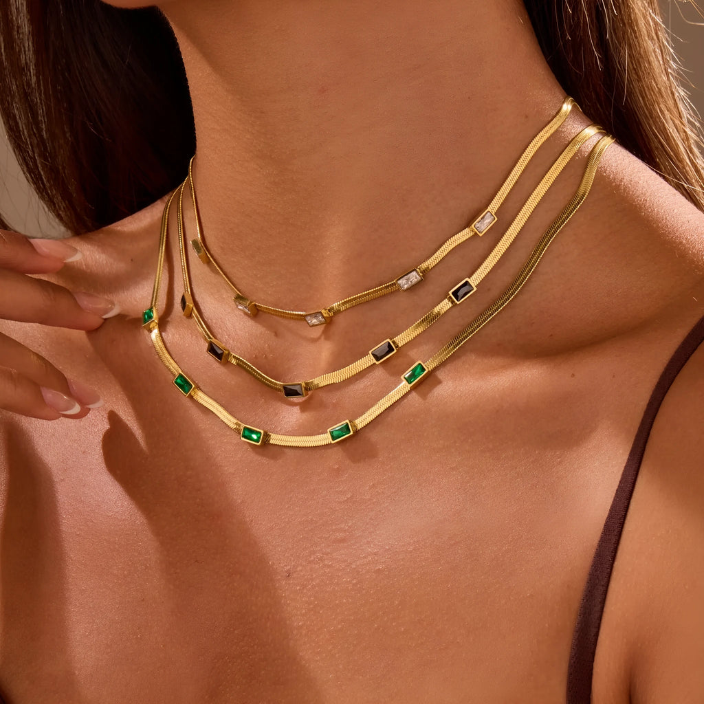 Geometric square zircon pendant on a stainless steel flat snake chain necklace with gold plating.
