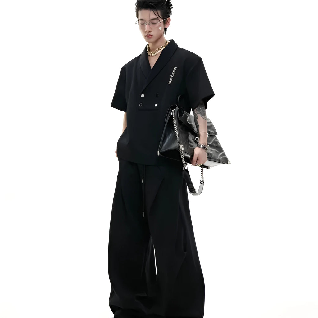 Men's dark grey cotton sports suit with V-neck short sleeve top featuring padded shoulders and metal embellishments with matching shorts