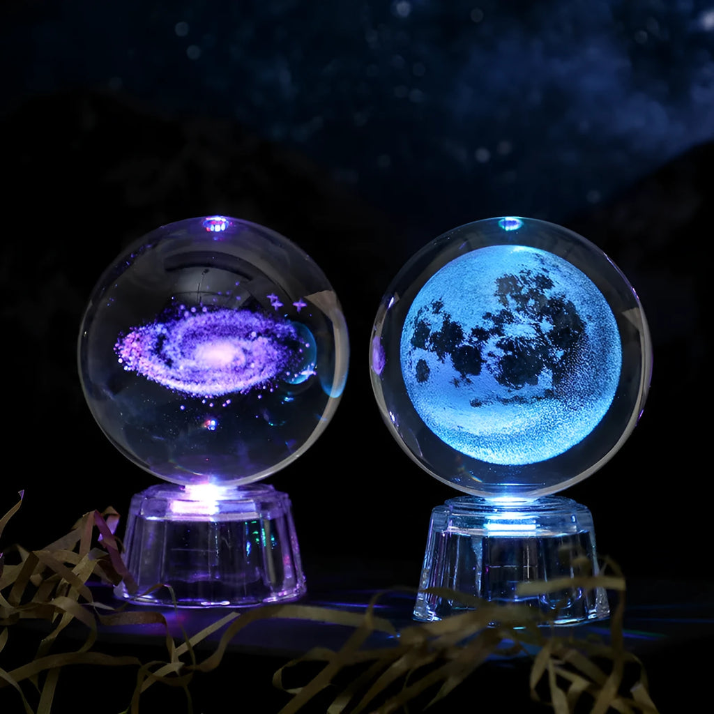 6cm transparent crystal ball ornament with illuminated inner carving of celestial designs on a table