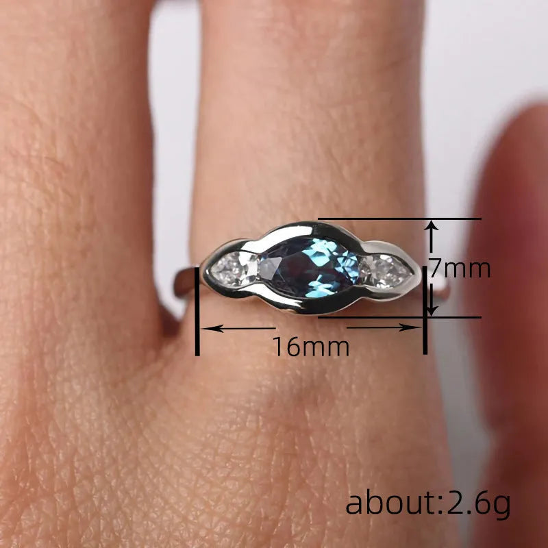 Geometric ellipse zircon ring in white gold finish on a copper band.