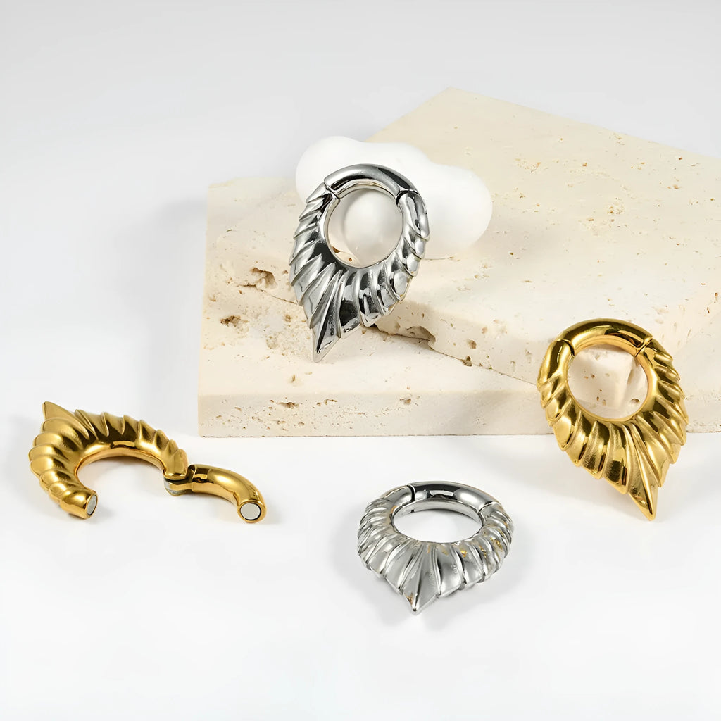 Stainless steel drop-shaped auricle ear extenders with round hanging egg motifs and totem detail.
