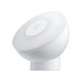 White modern Mijia induction bedside lamp with compact cubic design on a table.