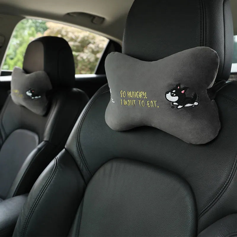 Car plush embroidery headrest shoulder pad with cute lion design in black on a car seat