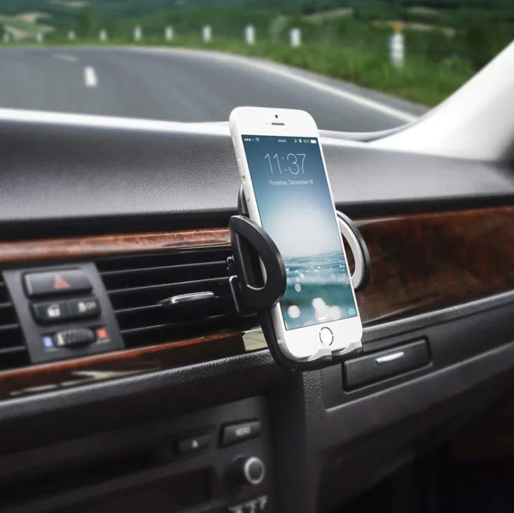 Universal black plastic car air vent mobile phone holder mounted on a car dashboard.