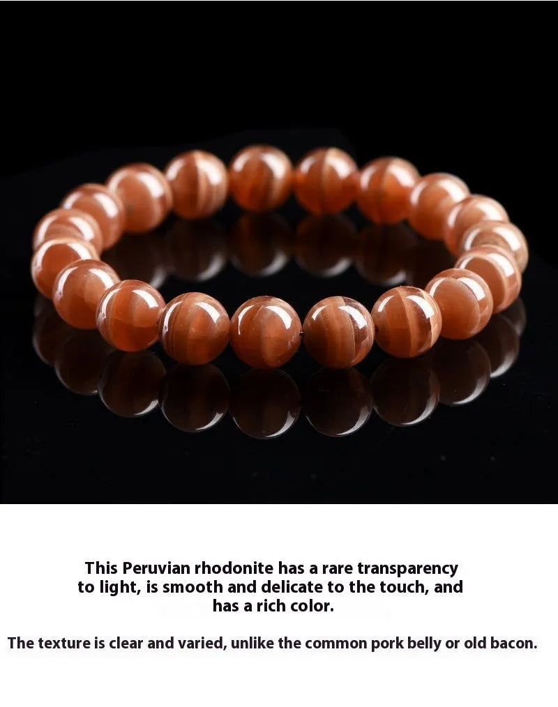Natural pink old mine rhodochrosite round bead bracelet with a silver Ruyi charm.