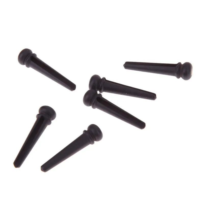 Six ebony folk guitar string nails with matt black finish and 5.3mm bayonet diameter