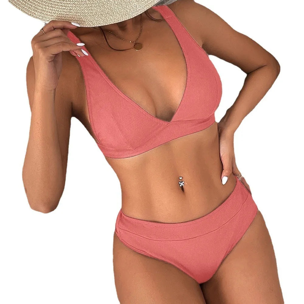 Women's black bikini set with lace-up front detail and high-leg split design.