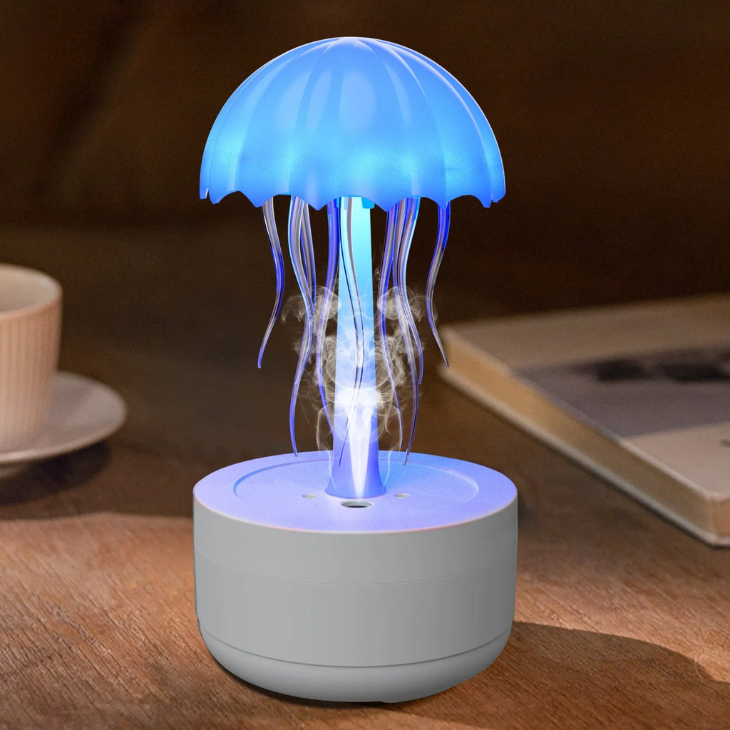 White jellyfish-shaped humidifier and essential oil diffuser with colourful night light on a desk.